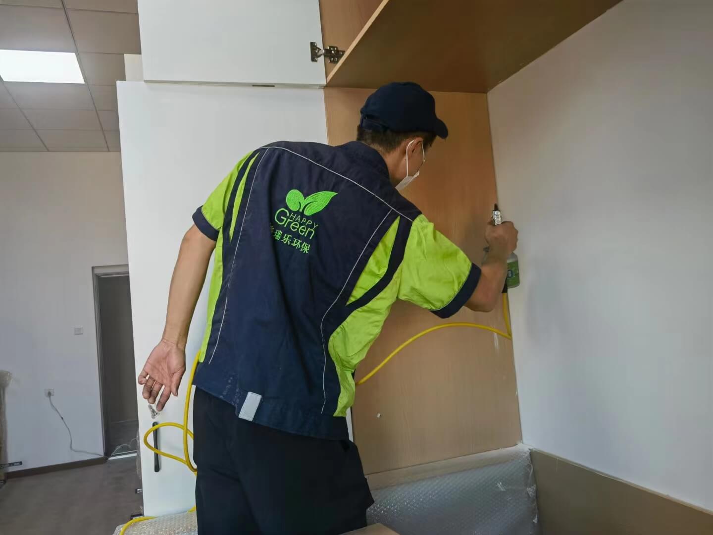 餐厅餐边柜的抽屉拉手的螺丝处，工人涂抹格瑞乐除甲醛防锈剂。